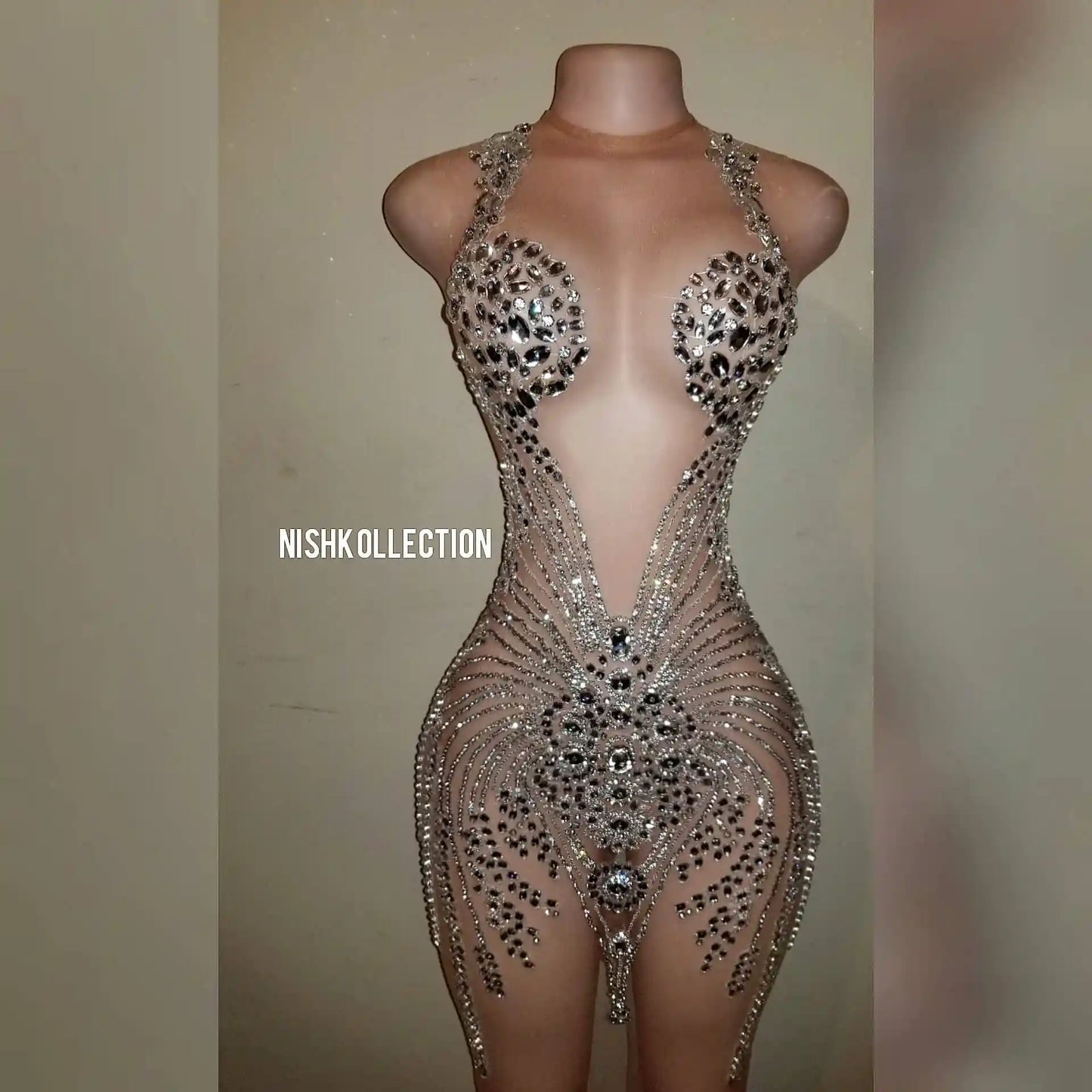 Close-up of rhinestone detailing on luxury mesh mini dress