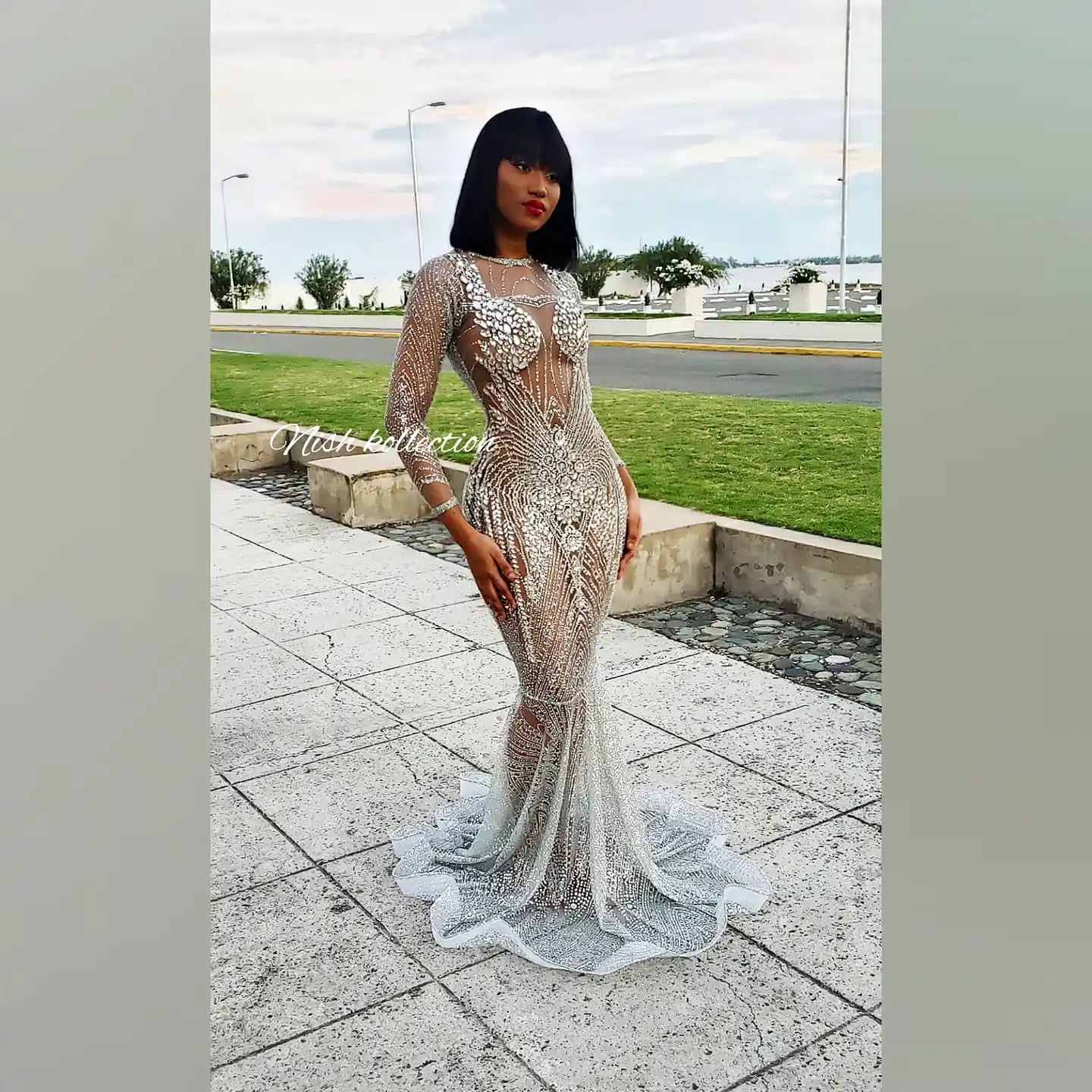 Model wearing London Shimmer Glitter Mermaid Dress with long sleeves and rhinestone details – front view